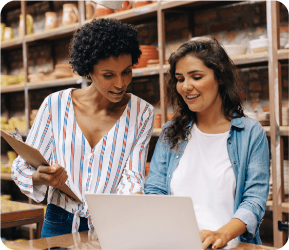 Two women working at a laptop