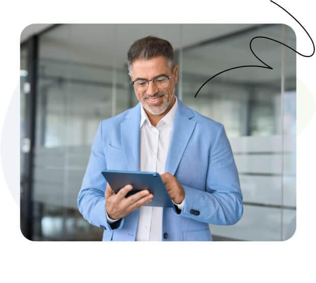 A businessman in a blue suit using a tablet.