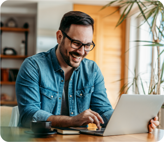 Man smiling at a laptop