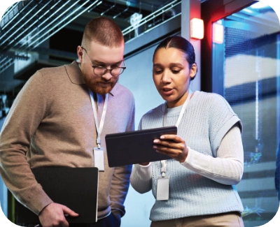 Two server technicians reviewing a security report for managed dedicated servers