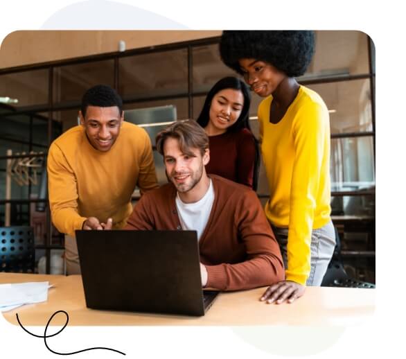 A diverse group of professionals collaborating on a laptop in a modern office setting.