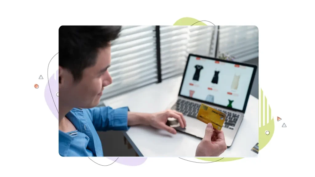 Person looking at a credit card paying for online shopping