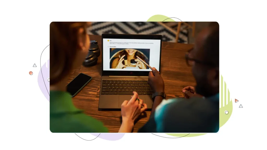 Two people checking something on a laptop