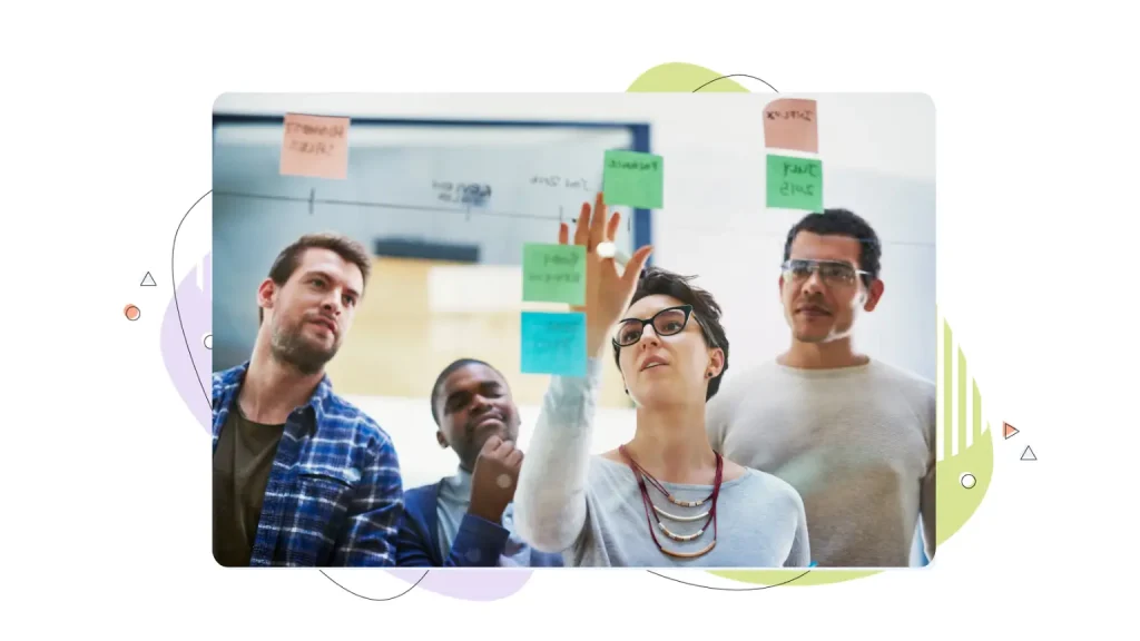 People looking at a clear board 