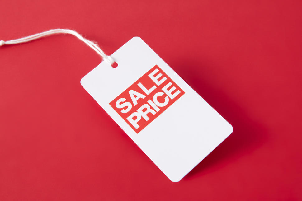 A closeupshot of a sales price tag on a red background - shopping concept