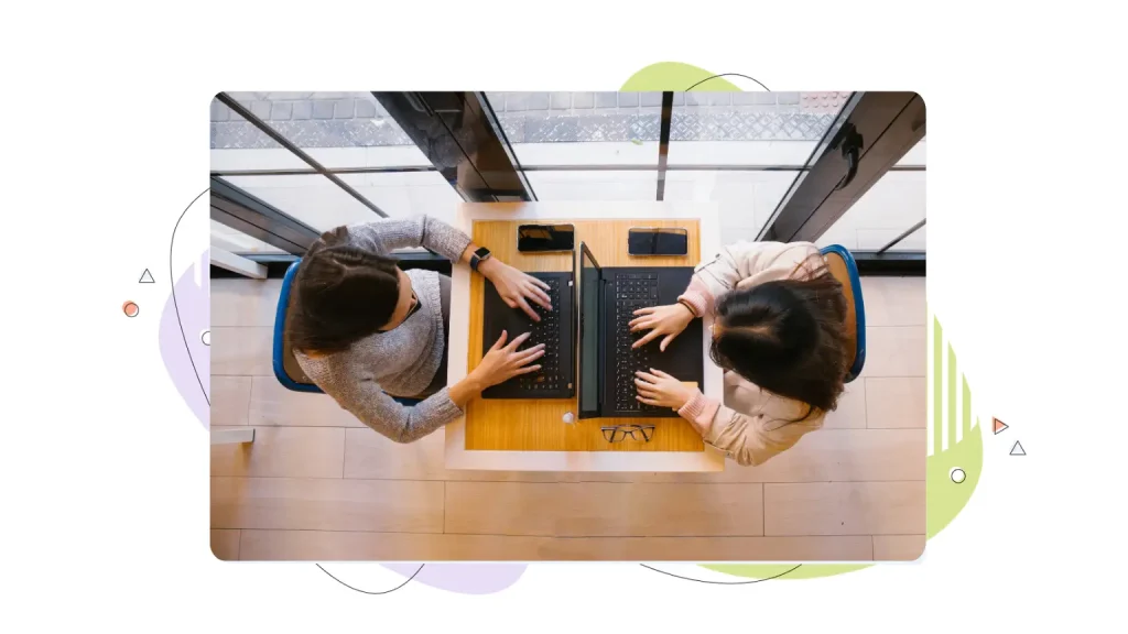 Two women working on laptops