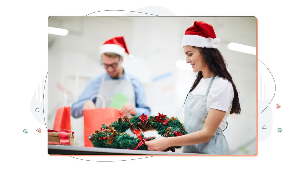 Florist making holiday wreath decorations