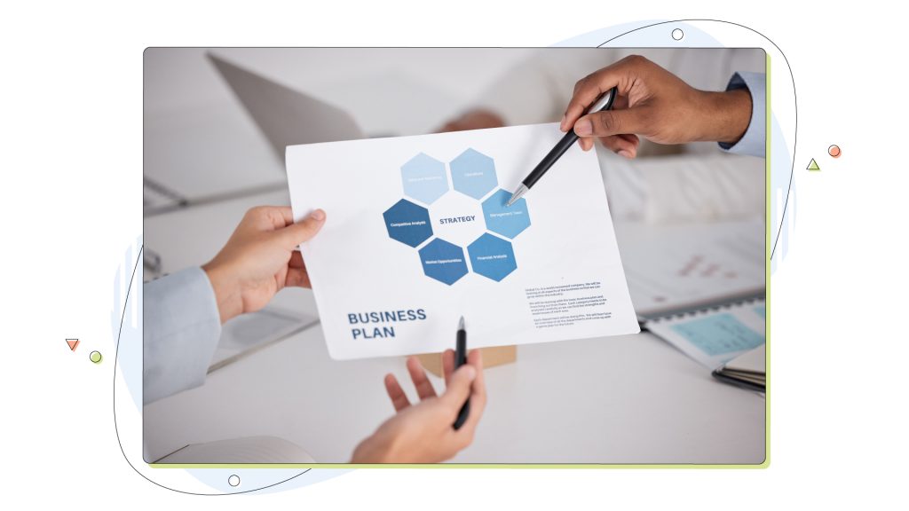 A group of businesspeople looking over paperwork in the boardroom.