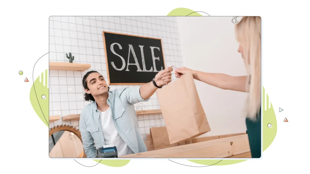 Seller giving a shopping bag to customer.