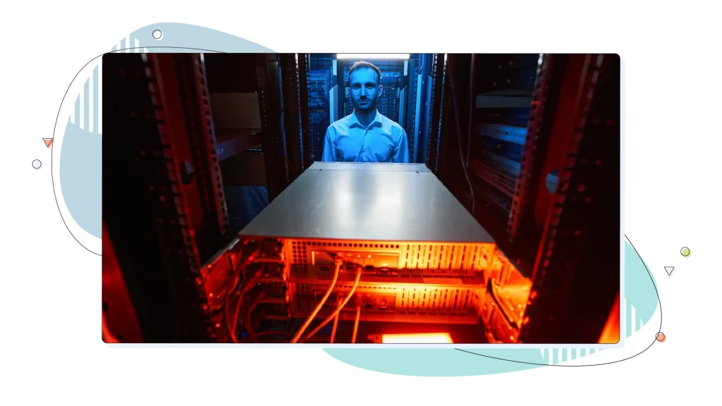 Server administrator standing before cabinet in data center.