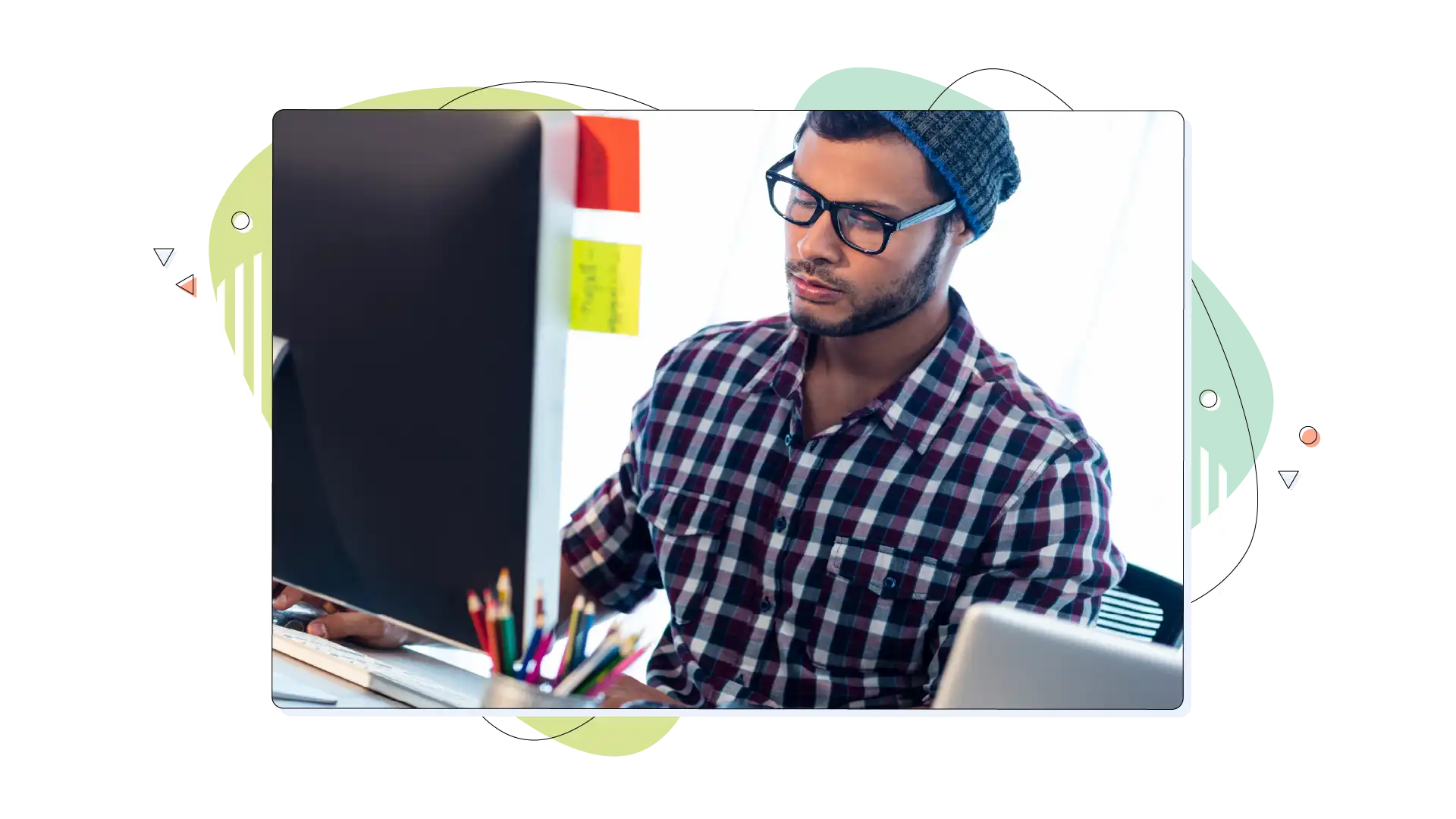 Web designer, working on a WordPress website, sitting in his office.