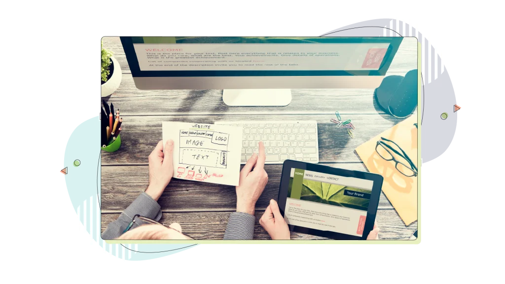 web designer holding a mockup of a website.