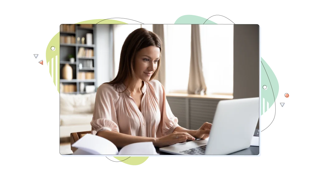 Woman working on her laptop, in a well lit room.