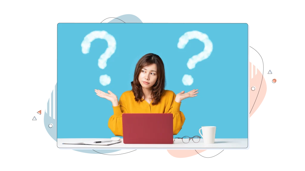 Woman with question mark icons over each of her shoulders, while working on her laptop.