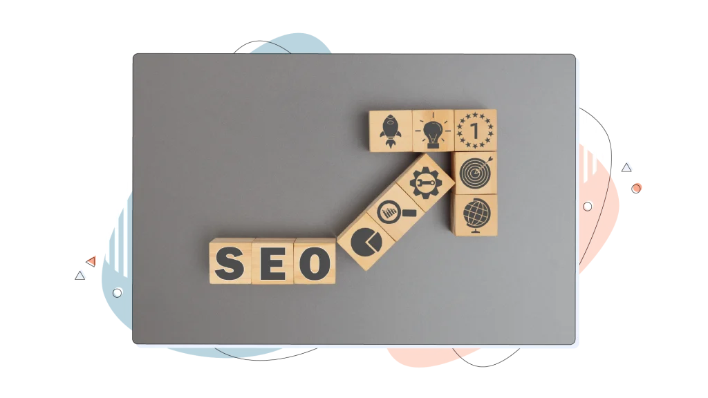 Wood bricks that read SEO on a grey surface.