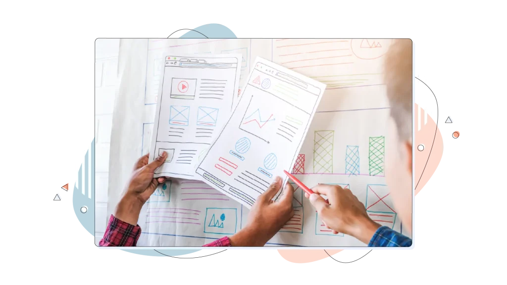 People working and looking at printed charts while a person is pointing at the document.