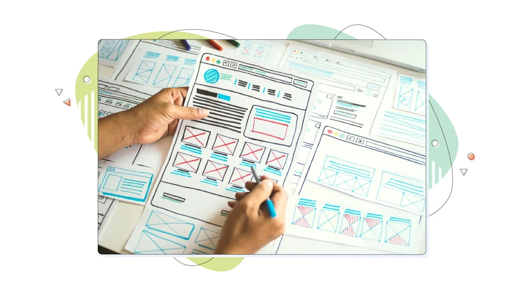 Person working on a website mockup on a piece of paper.
