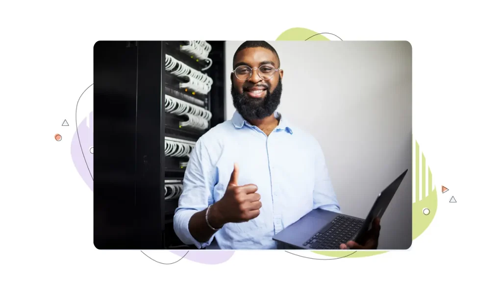 Smiling man holding a computer