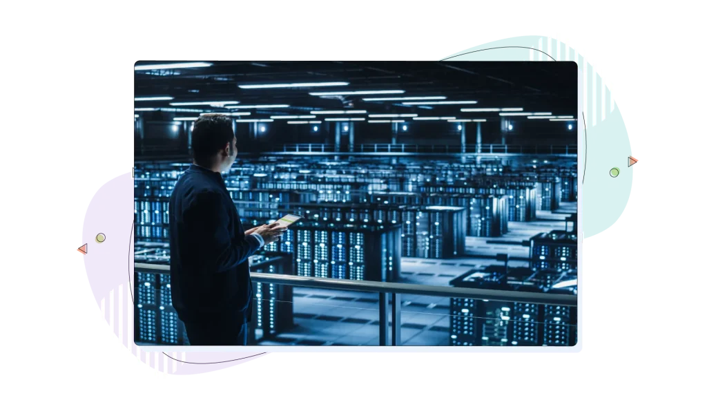 Person standing in a data centre and holding a notebook.