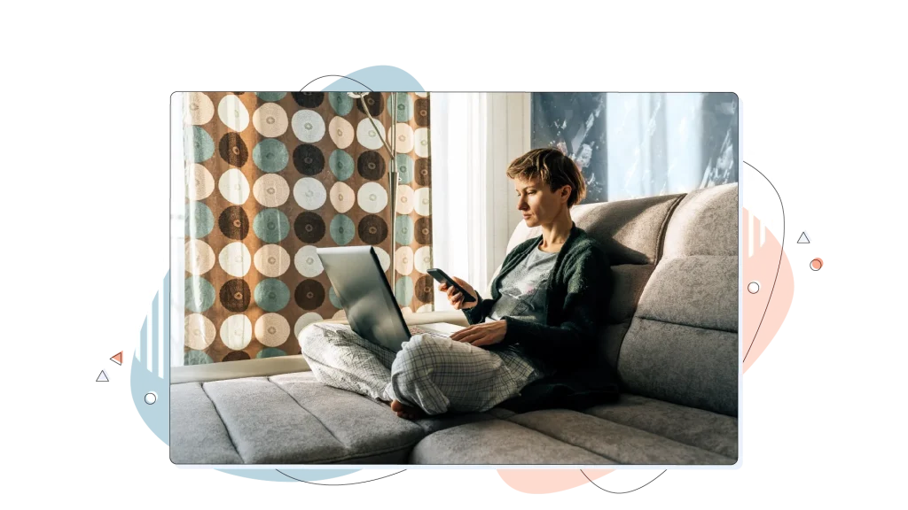 Woman sitting on her sofa and working on her laptop.