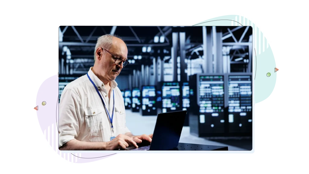 Person working on their laptop in a data centre.