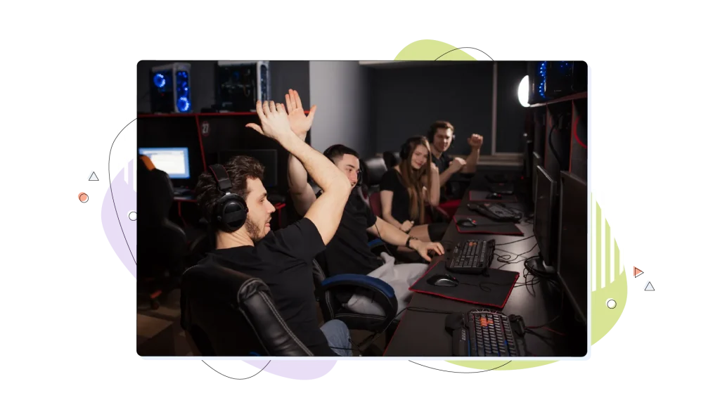 Gamers in a gaming room congratulating themselves over a win.