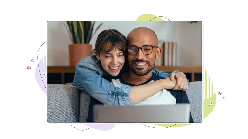 Couple hugging while looking at their healthy WordPress website on their laptop. 