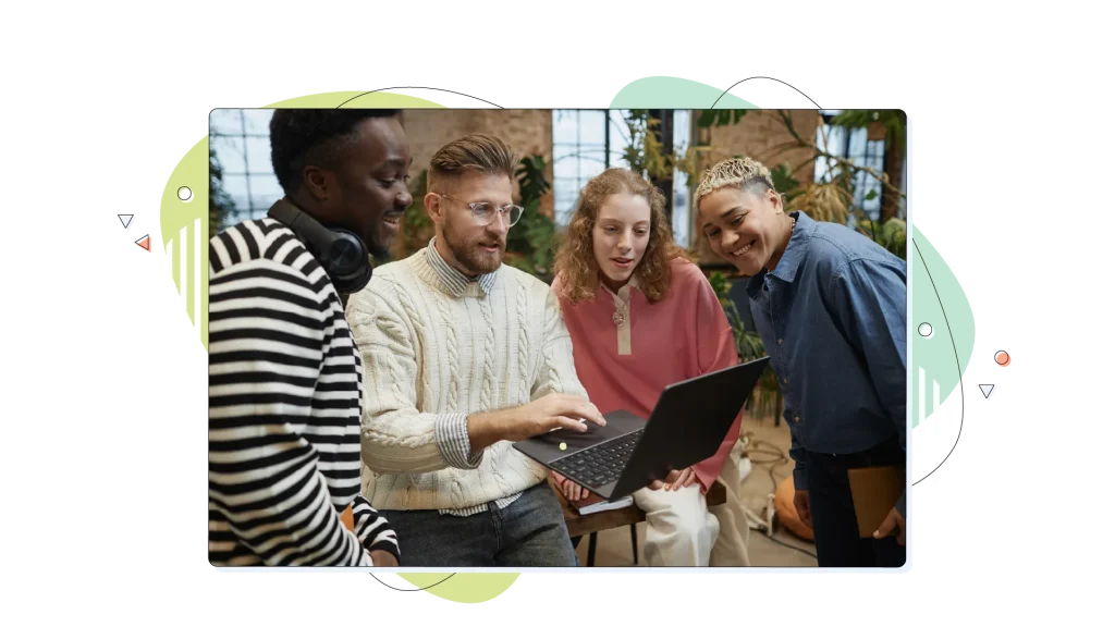 Group of developers looking at their website on a laptop computer.