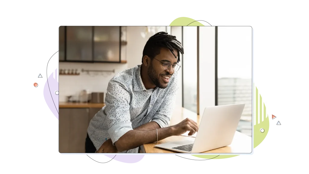 Man looking at laptop, smiling.