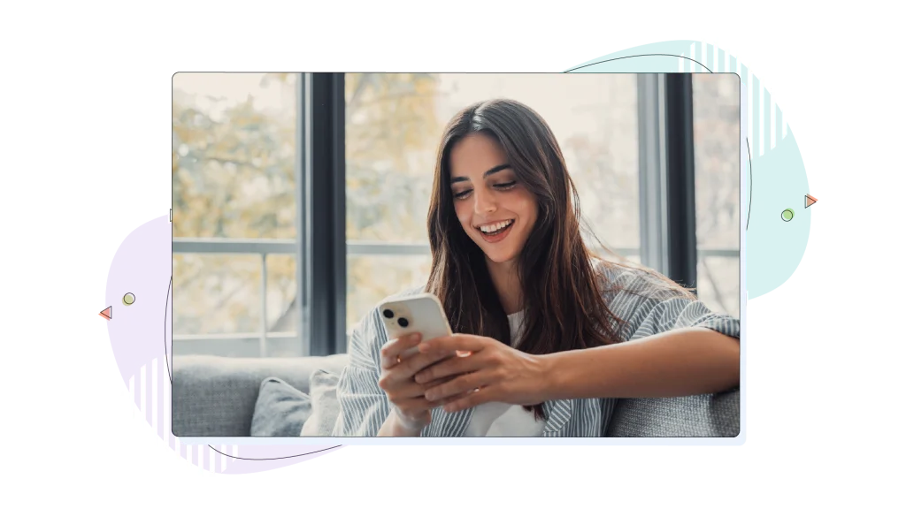 Woman smiling while holding her smartphone.