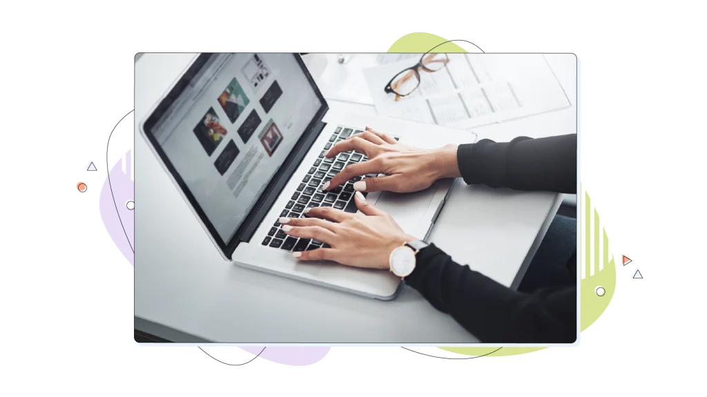 Woman typing on her laptop computer on her desk.