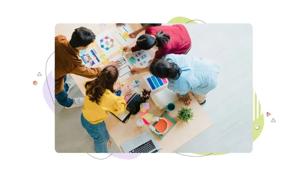 A group of young people in casual wear discussing a business brainstorming meeting in an office.
