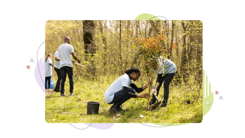 A team of two activists doing voluntary work to plant trees in the forest.
