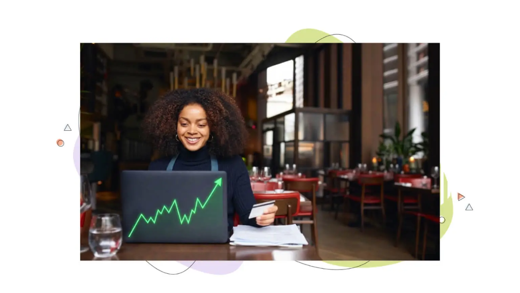 A young woman in her coffee shop looking at business results on a laptop to review domain value estimation steps.