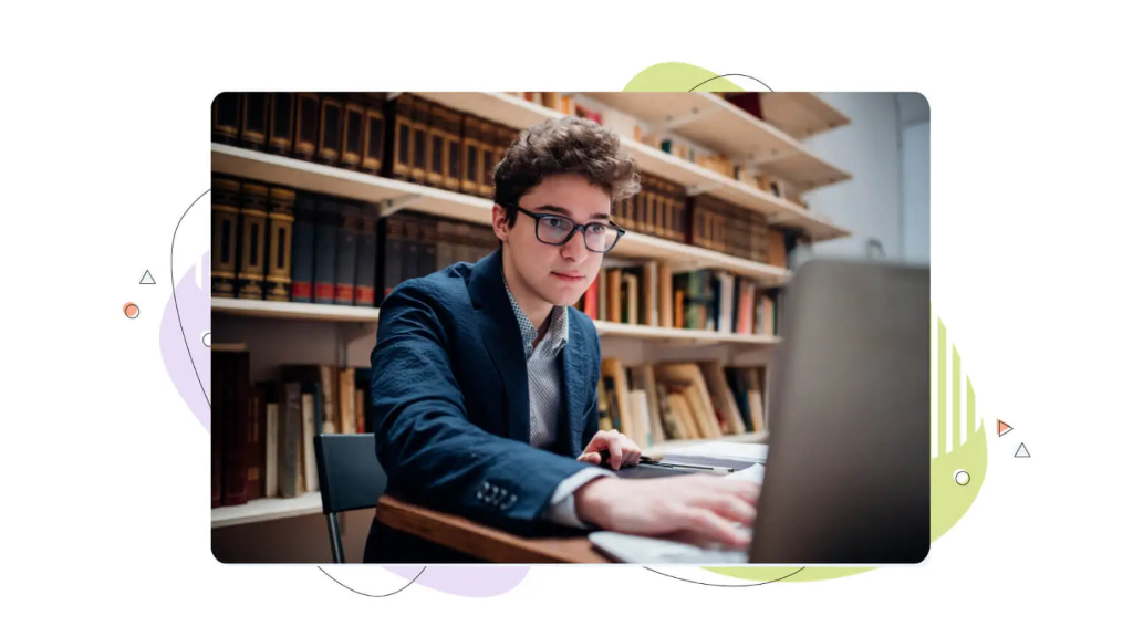 A young man in a library surrounded by books examining a computer screen to learn what determines domain value.