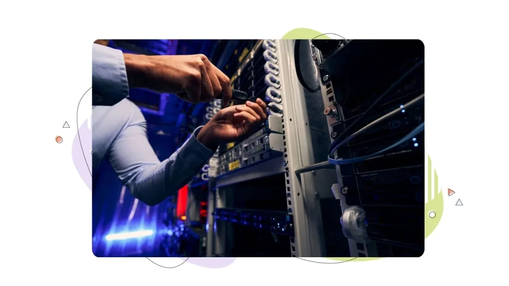 Person working on a server rack with a screwdriver.