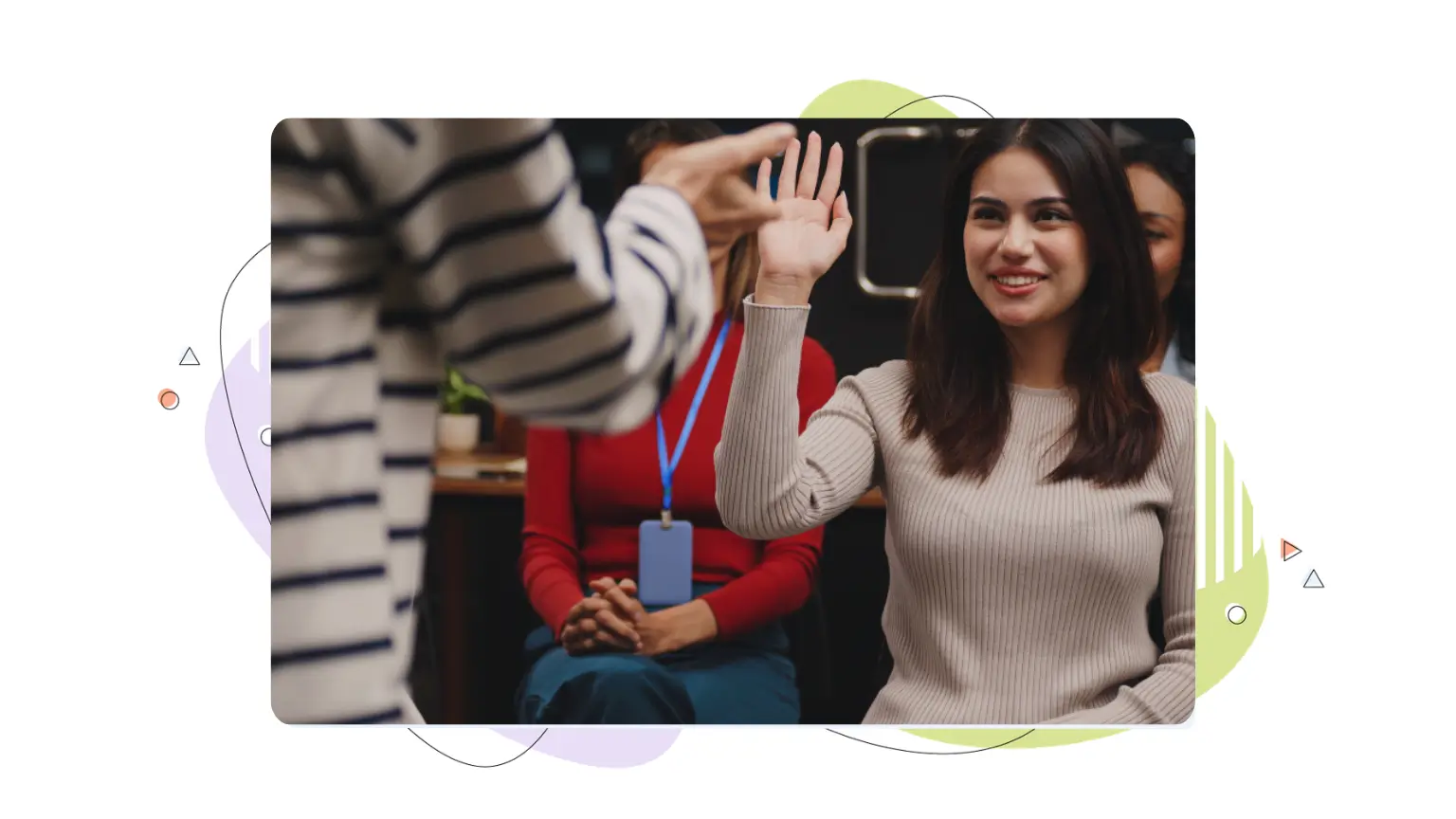 A smiling woman raising her hand in an audience during a seminar, symbolizing concepts on how to get cited by AI.