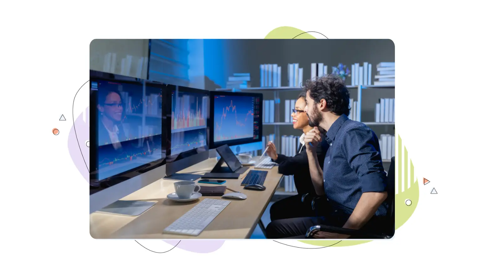 Two professionals analyzing performance graphs on multiple desktop monitors, illustrating AI visibility tracking strategies.